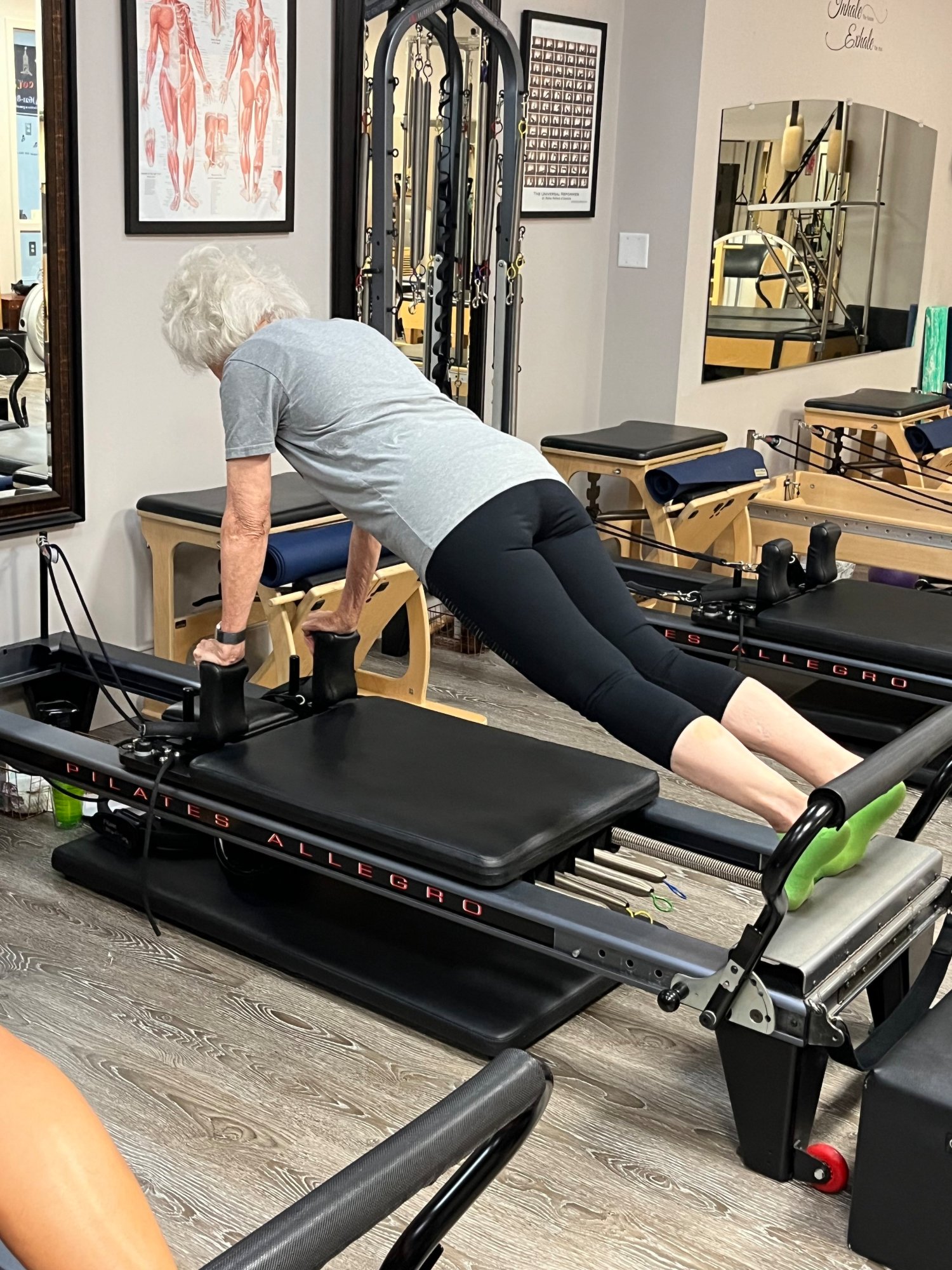 A client holding a plank on a Balanced Body reformer in the studio
